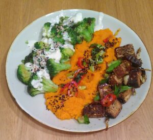 Serviervorschlag von Karottenpüree it Sesambrokkoli, Knuspertofu und Joghurtsoße